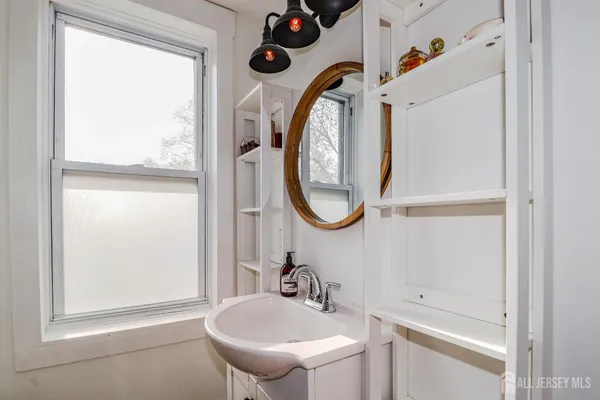 a bedroom with a bed dresser and a window