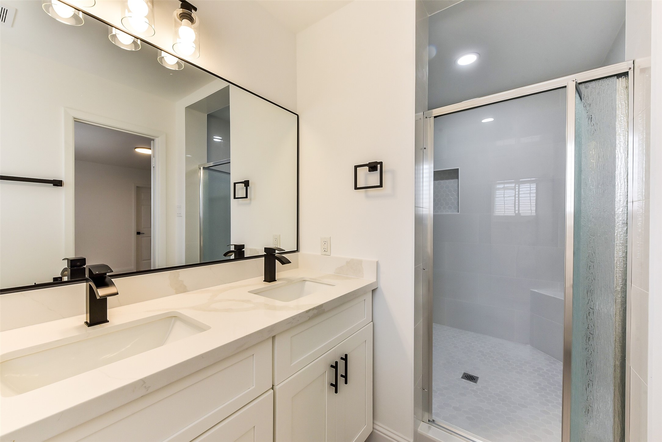 5946 Valkeith Drive Houston, TX 77096 - Photo 23 of 32 a bathroom with a sink a shower and a mirror