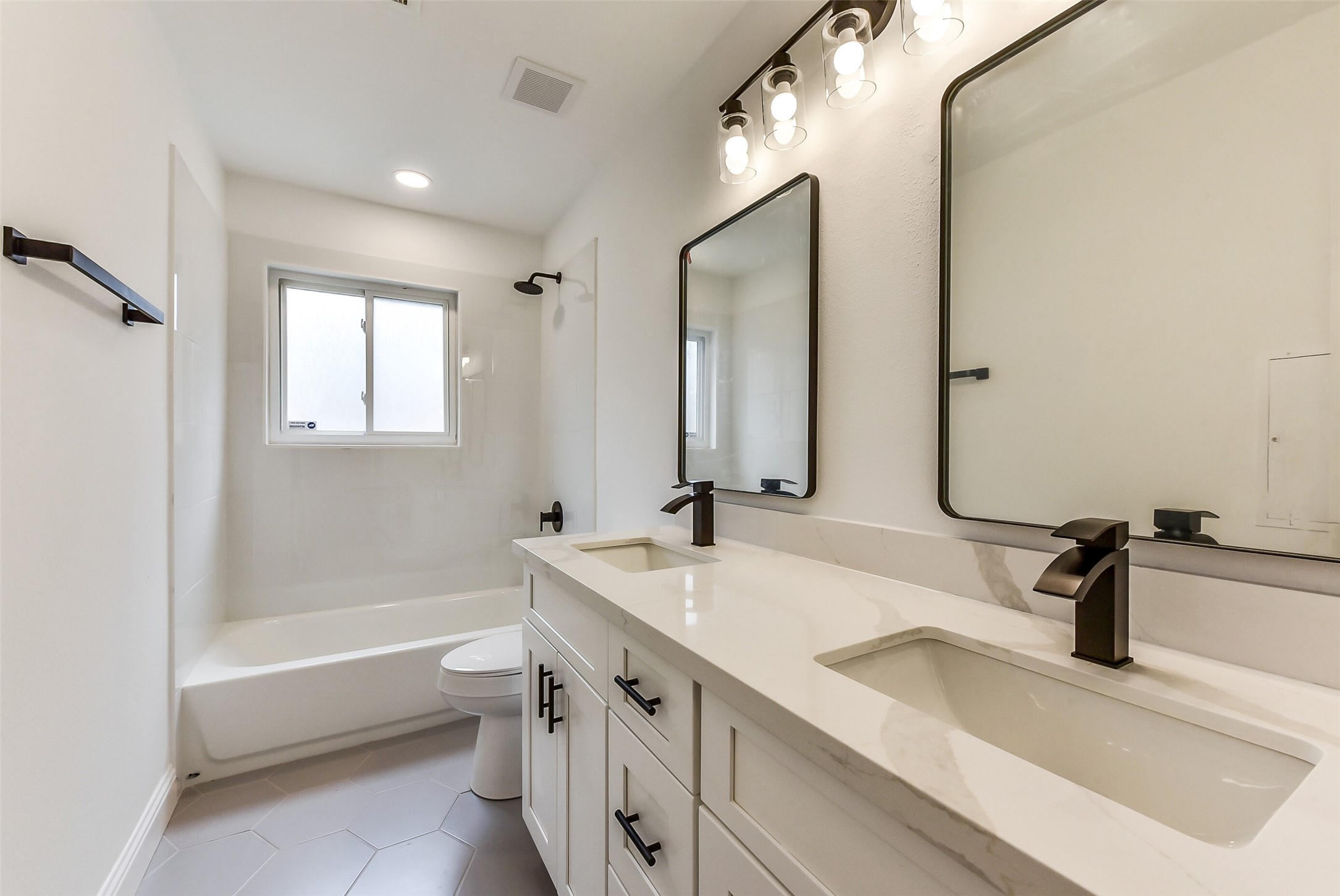 5946 Valkeith Drive Houston, TX 77096 - Photo 29 of 32 a bathroom with a tub sink and mirror