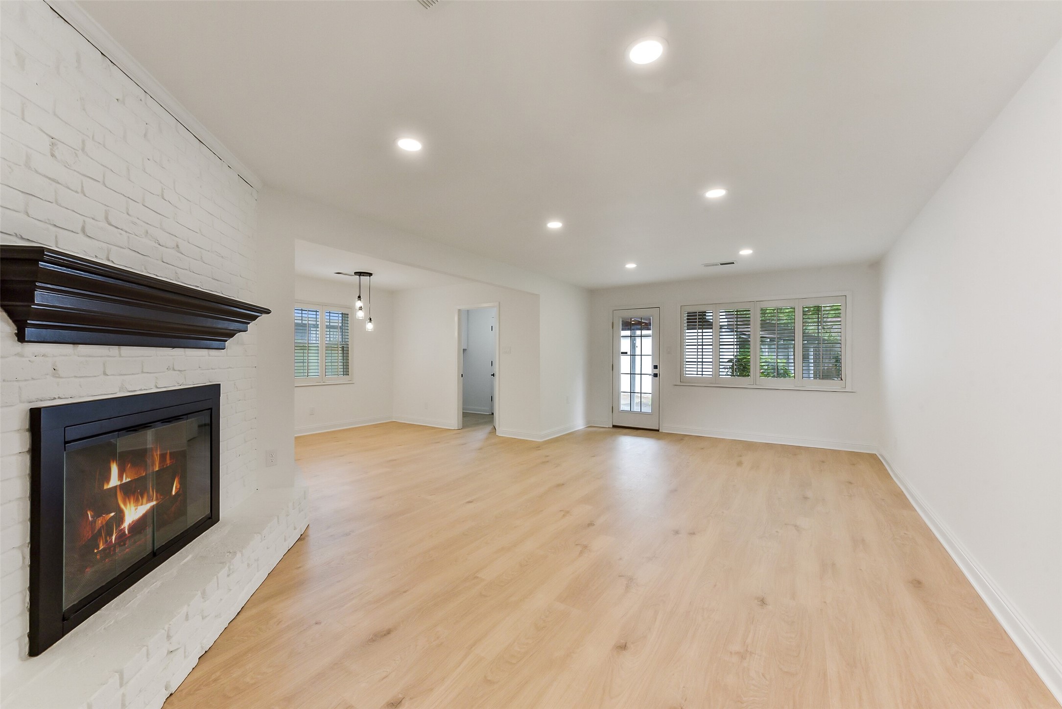 5946 Valkeith Drive Houston, TX 77096 - Photo 6 of 32 a view of an empty room with a fireplace and a window