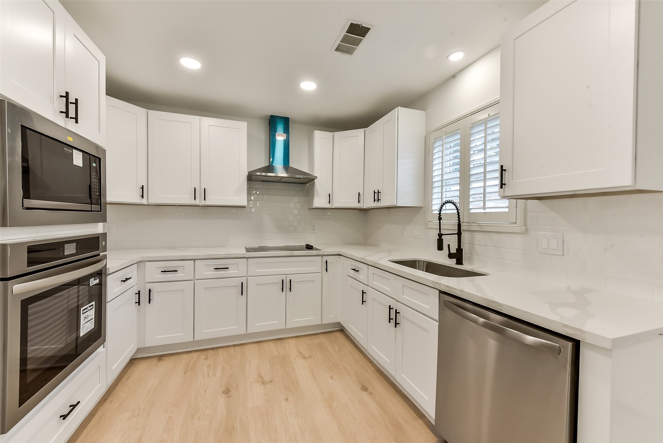 5946 Valkeith Drive Houston, TX 77096 - Photo 9 of 32 a large kitchen with stainless steel appliances granite countertop a sink a stove a microwave and cabinets