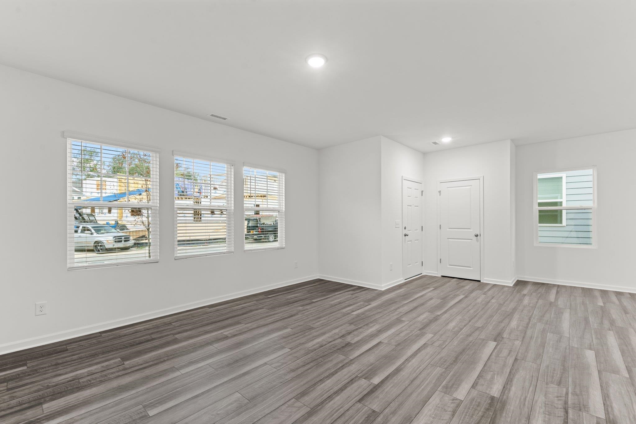 325 Spaight Acrs Way Wake Forest, NC 27587 - Photo 11 of 54 a view of an empty room with wooden floor and a window