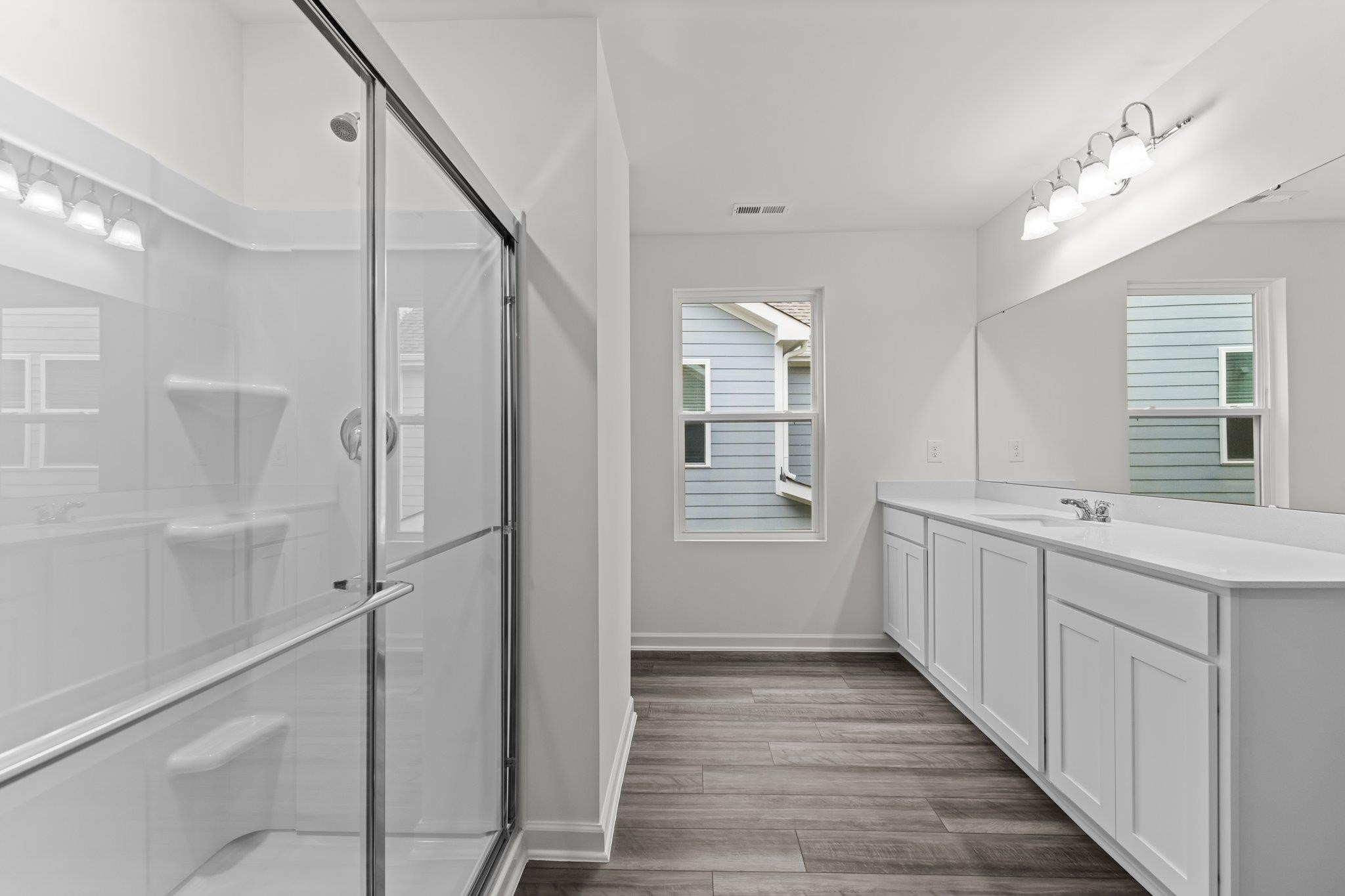 325 Spaight Acrs Way Wake Forest, NC 27587 - Photo 13 of 54 a bathroom with a double vanity sink a toilet and shower