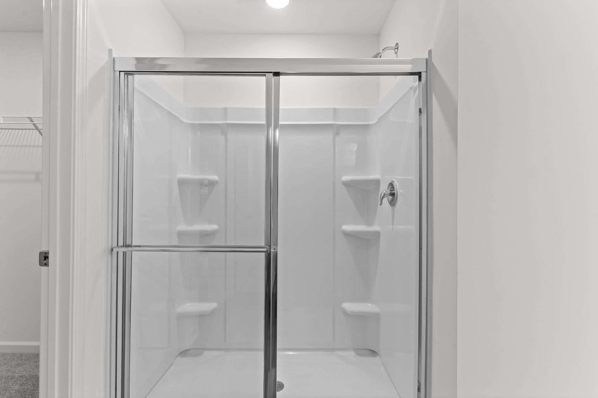 325 Spaight Acrs Way Wake Forest, NC 27587 - Photo 14 of 54 a bathroom with a glass shower door