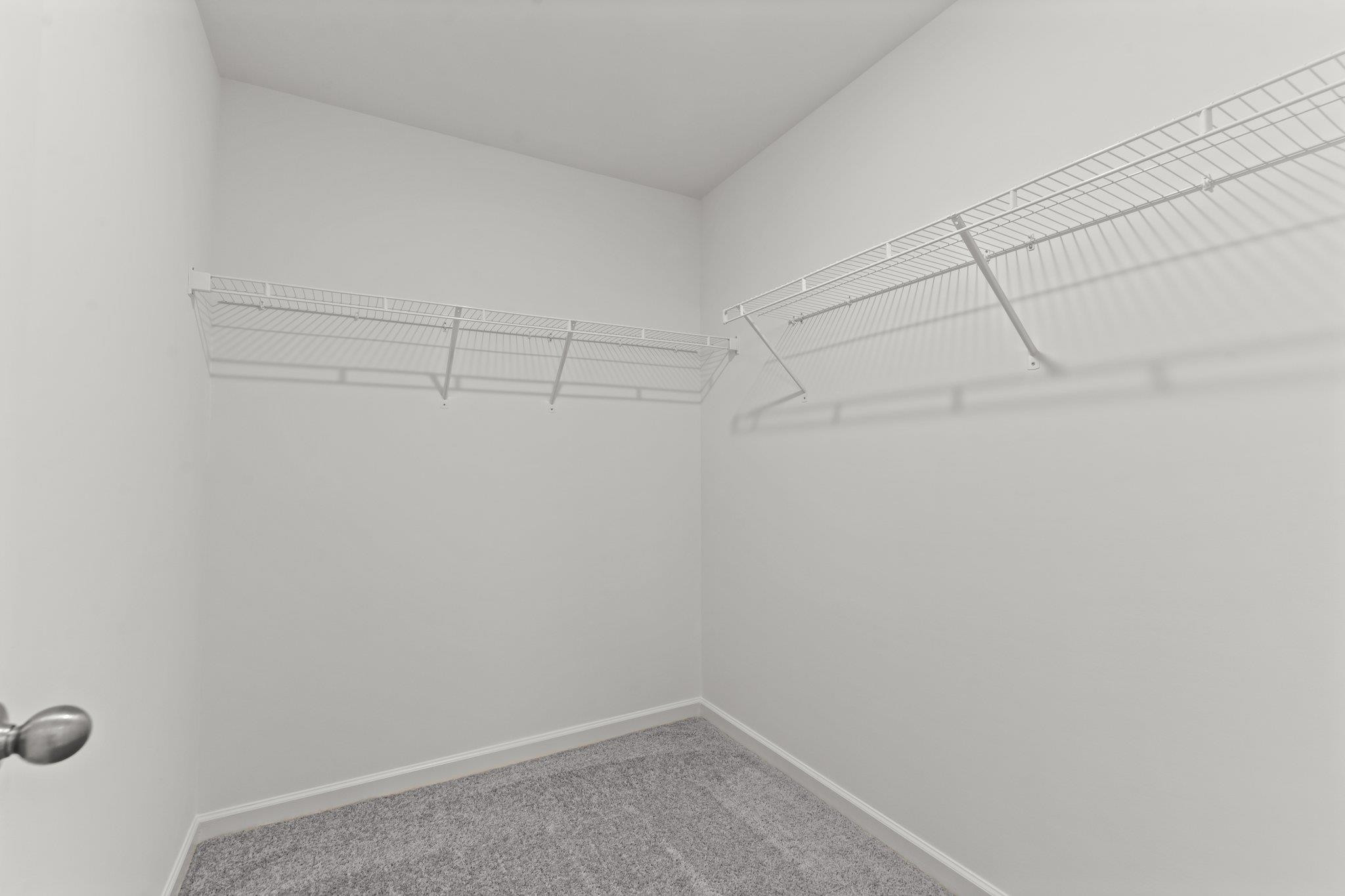 325 Spaight Acrs Way Wake Forest, NC 27587 - Photo 16 of 54 a view of a room with racks on the wall