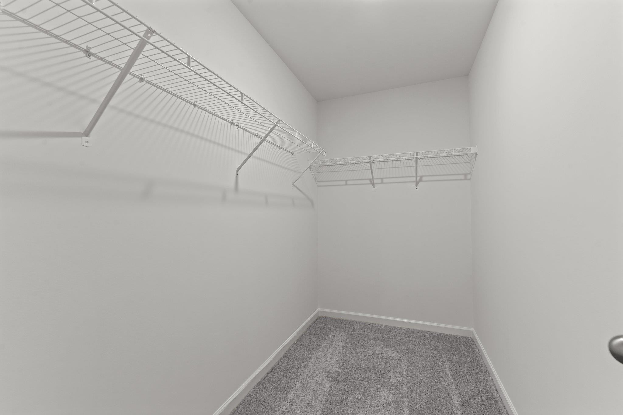 325 Spaight Acrs Way Wake Forest, NC 27587 - Photo 17 of 54 a view of a room with racks on the wall