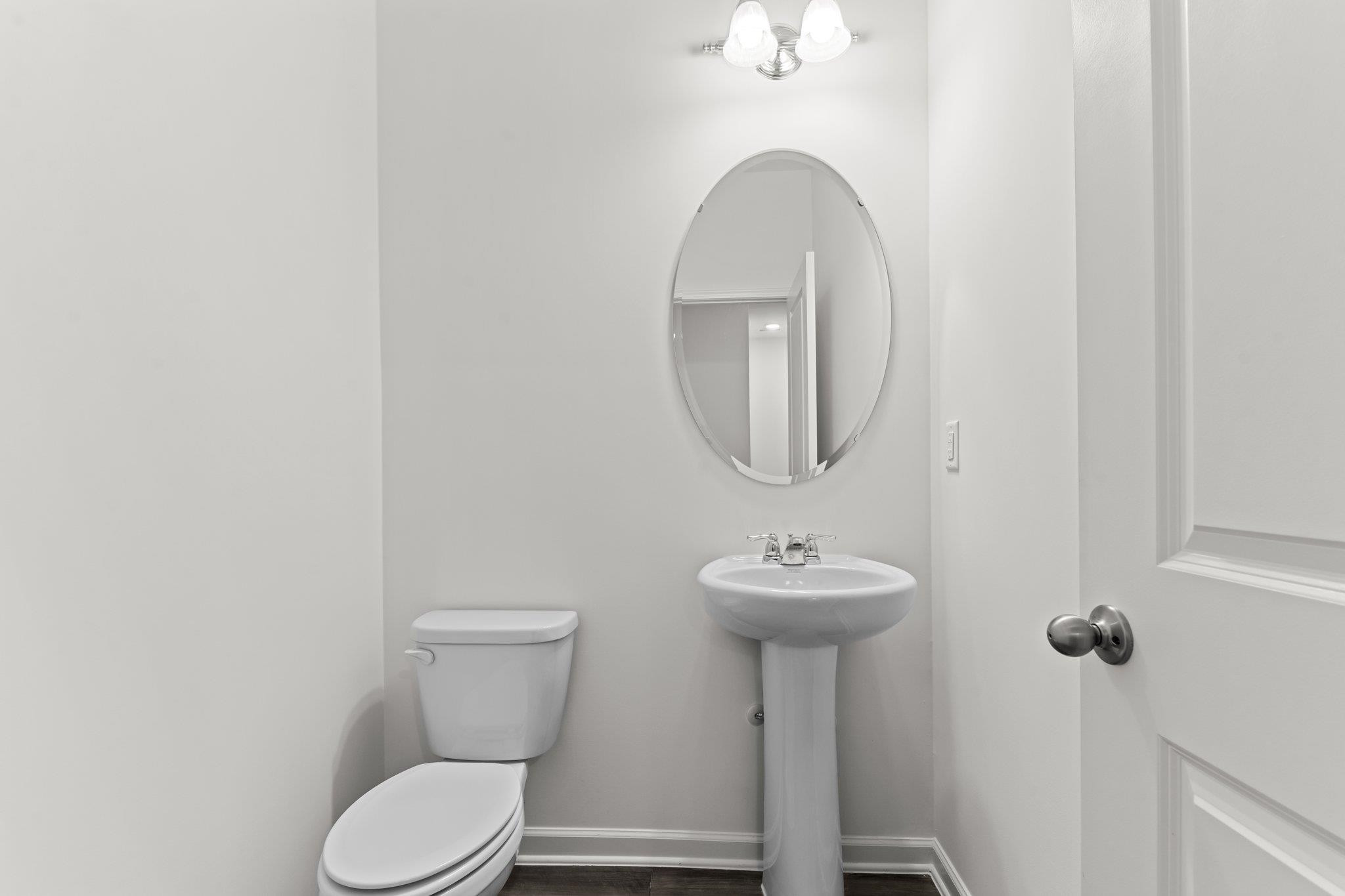 325 Spaight Acrs Way Wake Forest, NC 27587 - Photo 21 of 54 a bathroom with a toilet sink and mirror