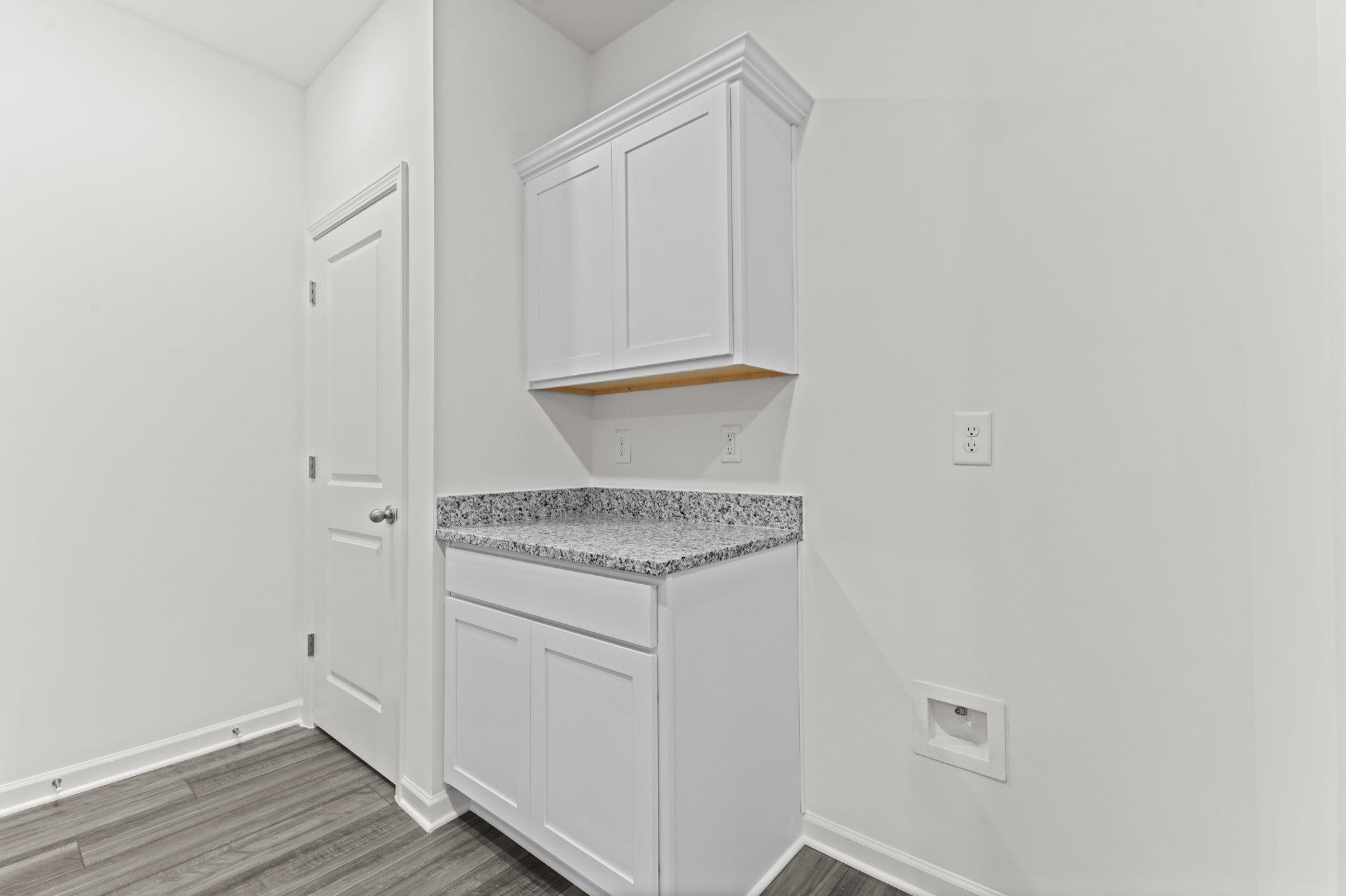 325 Spaight Acrs Way Wake Forest, NC 27587 - Photo 28 of 54 a view of a utility room with wooden floor