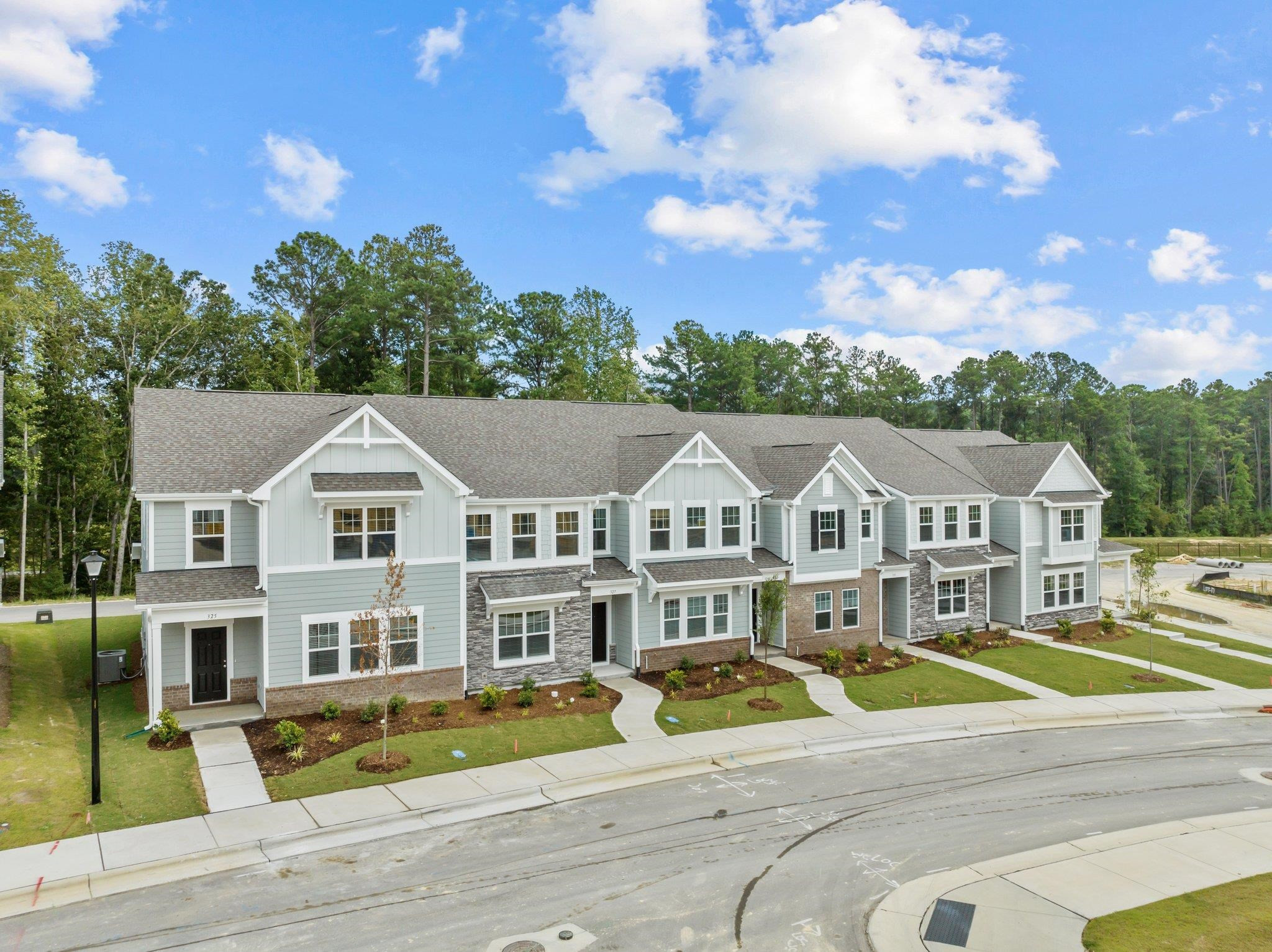 325 Spaight Acrs Way Wake Forest, NC 27587 - Photo 36 of 54 a view of a big house with a big yard and large trees