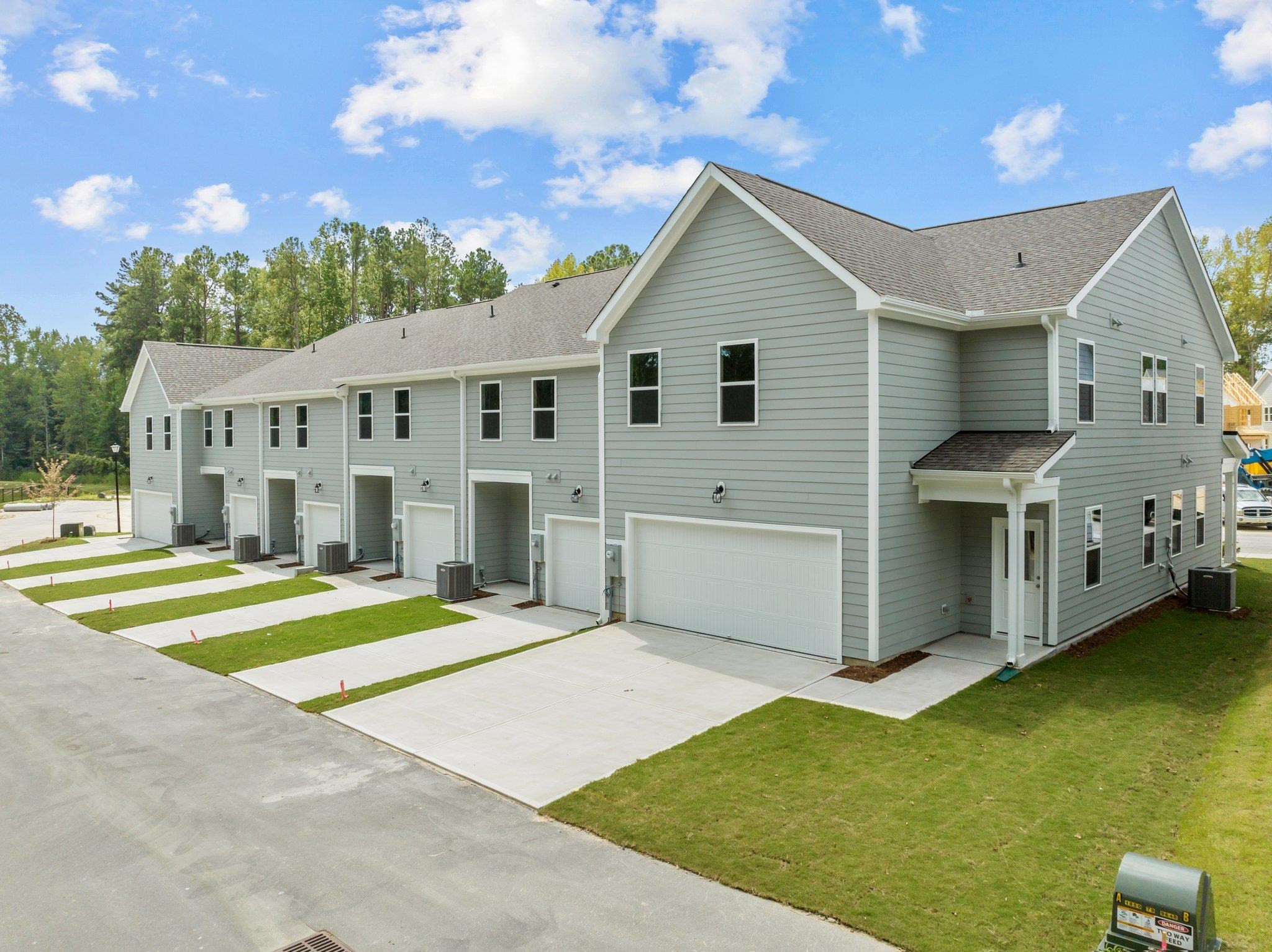 325 Spaight Acrs Way Wake Forest, NC 27587 - Photo 38 of 54 a view of a white house with a big yard and large trees