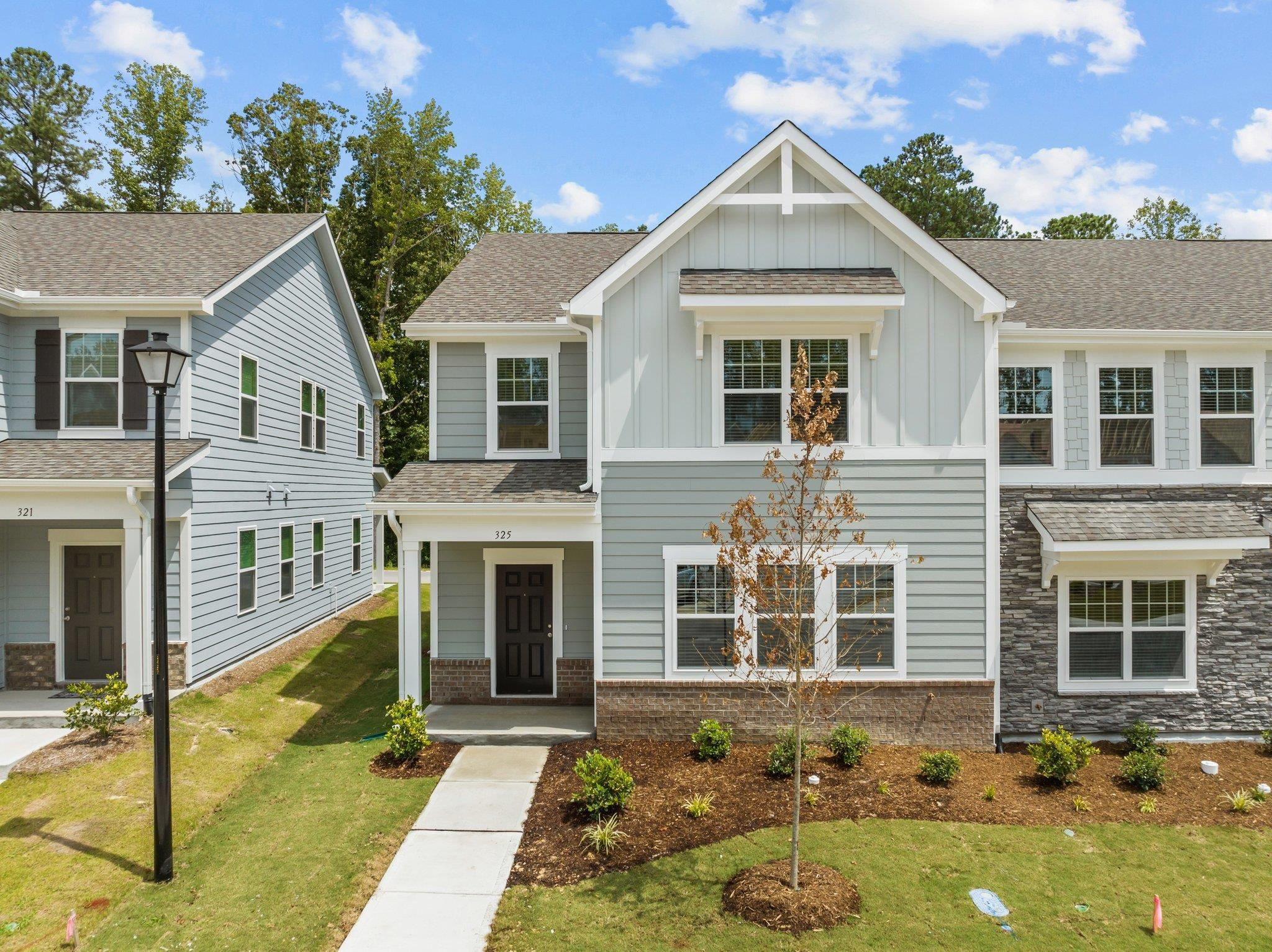 325 Spaight Acrs Way Wake Forest, NC 27587 - Photo 39 of 54 a front view of a house with garden