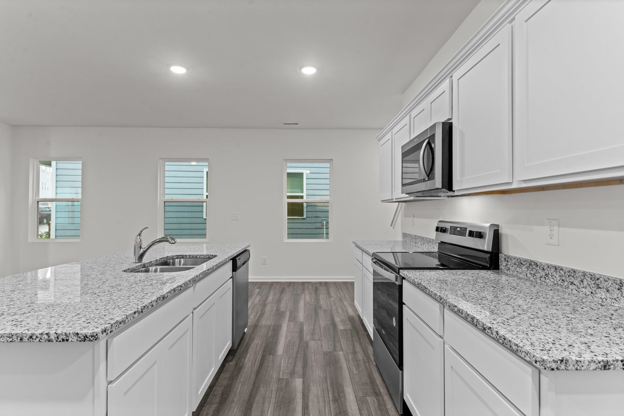 325 Spaight Acrs Way Wake Forest, NC 27587 - Photo 4 of 54 a kitchen with granite countertop stainless steel appliances a sink stove top oven and cabinets