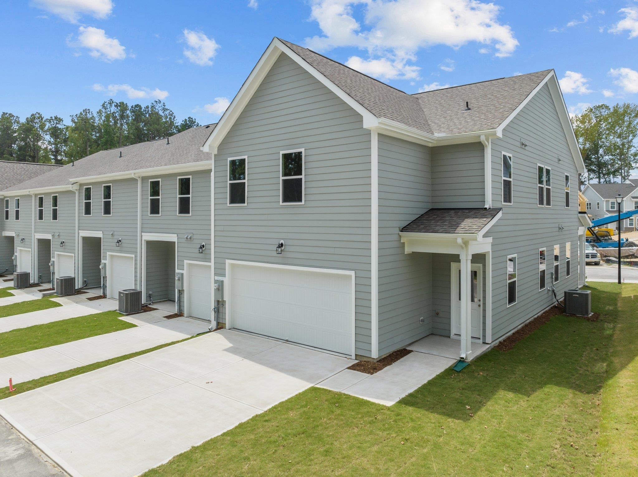325 Spaight Acrs Way Wake Forest, NC 27587 - Photo 42 of 54 a view of a white house with a big yard and large tree