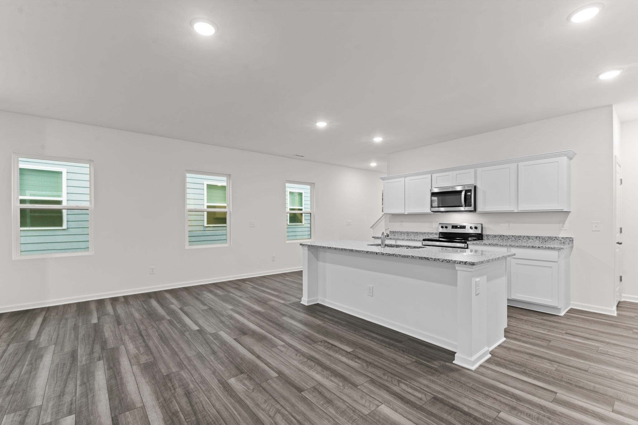 325 Spaight Acrs Way Wake Forest, NC 27587 - Photo 6 of 54 a kitchen with stainless steel appliances a stove top oven a sink and white cabinets