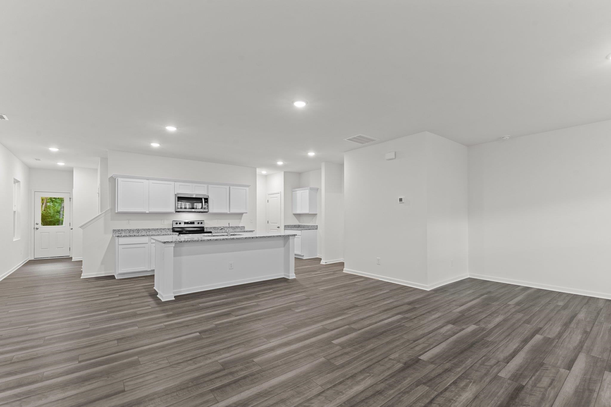 325 Spaight Acrs Way Wake Forest, NC 27587 - Photo 7 of 54 a view of kitchen with wooden floor and electronic appliances