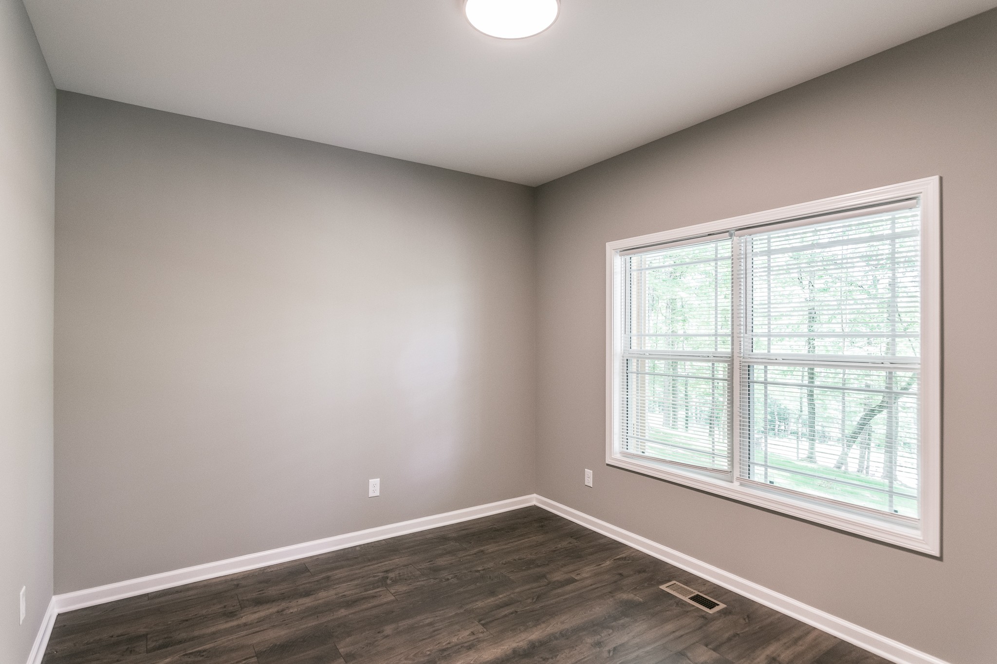 1566 Old Gallatin Road Portland, TN 37148 - Photo 14 of 49 an empty room with wooden floor and windows