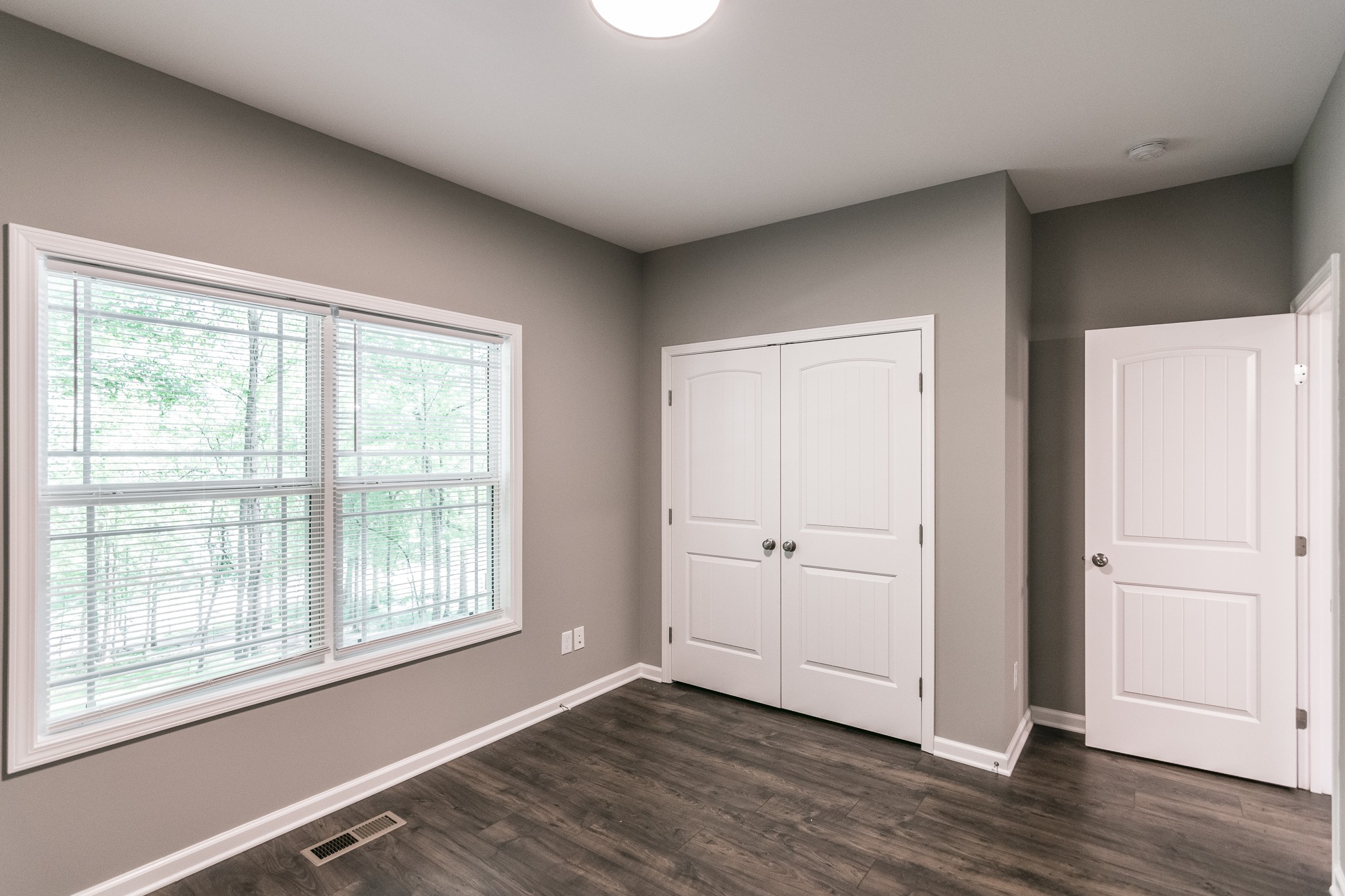 1566 Old Gallatin Road Portland, TN 37148 - Photo 15 of 49 an empty room with wooden floor and windows