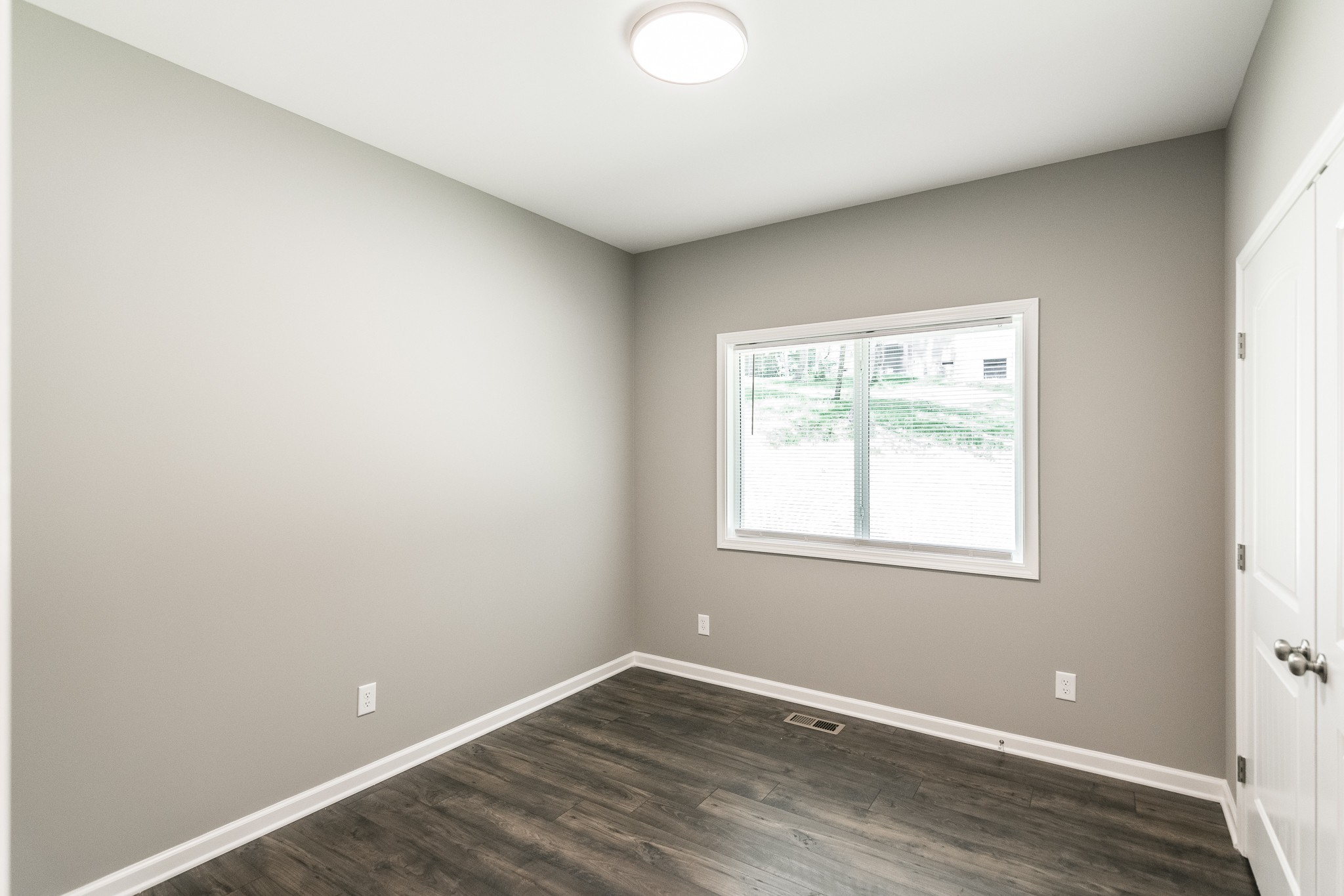 1566 Old Gallatin Road Portland, TN 37148 - Photo 17 of 49 an empty room with wooden floor and windows