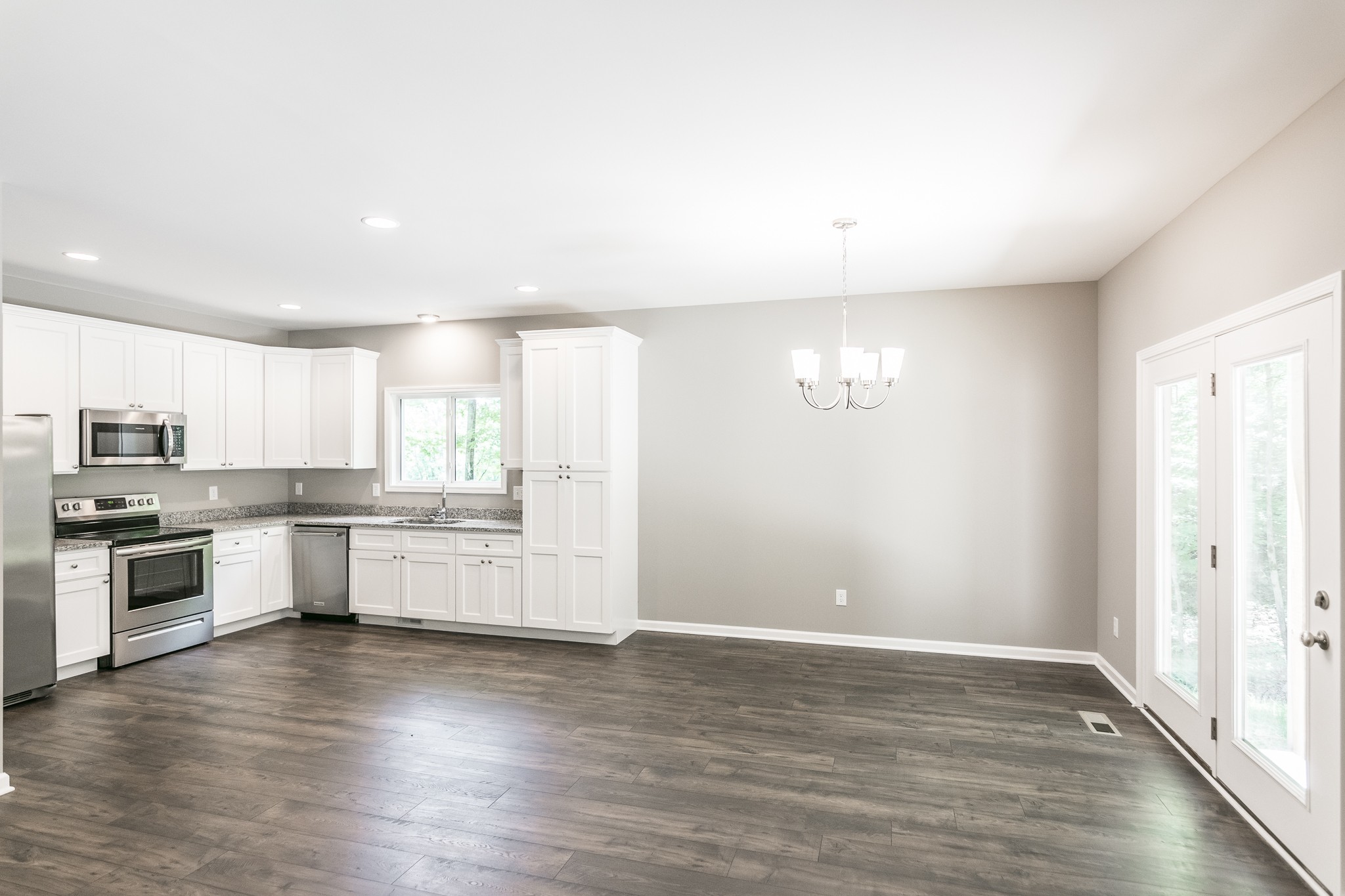 1566 Old Gallatin Road Portland, TN 37148 - Photo 22 of 49 a large kitchen with cabinets wooden floor and stainless steel appliances