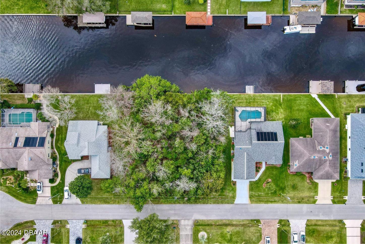 an aerial view of a house with a garden and yard