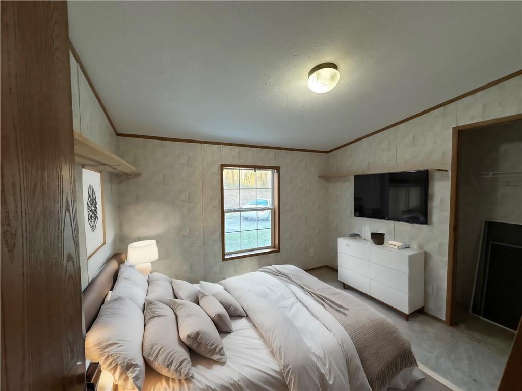 137 Lucas Pipeline Road Ruffs Dale, PA 15679 - Photo 15 of 35 a bedroom with a bed and a flat screen tv