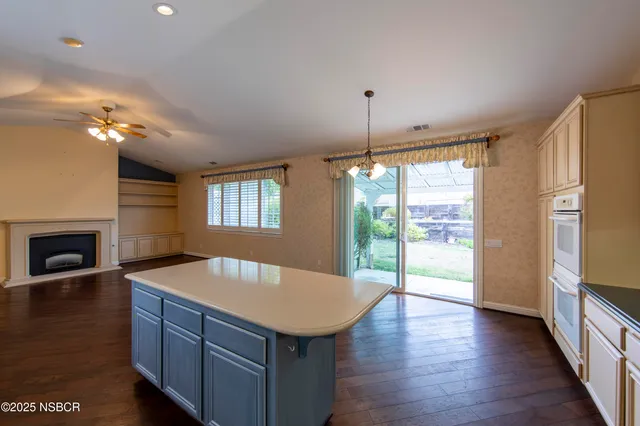 a kitchen with a sink a stove and cabinets