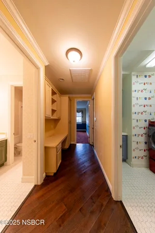 a view of a hallway with wooden floor