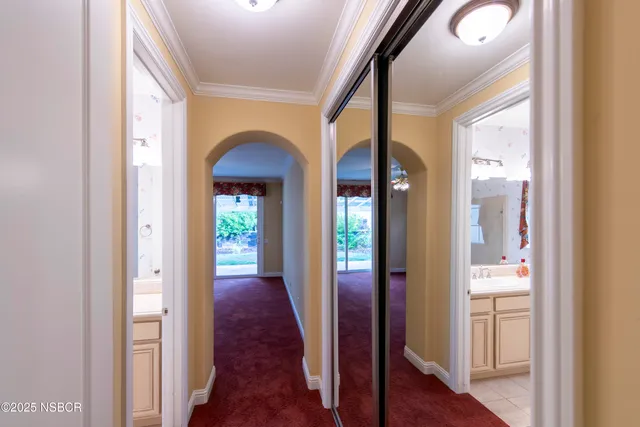 an empty room with windows chandelier fan