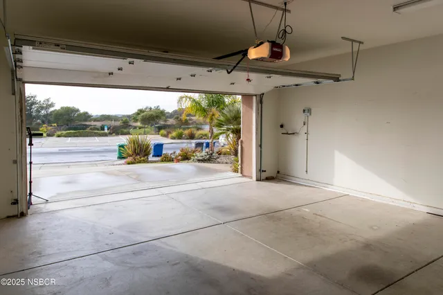 a front view of a house with plants