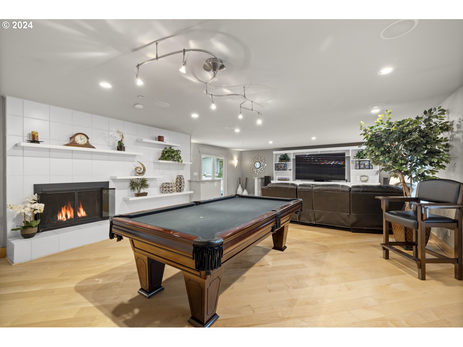 8857 Southwest Edgewood Street Tigard, OR 97223 - Photo 22 of 48 a living room with furniture a pool table and a fireplace