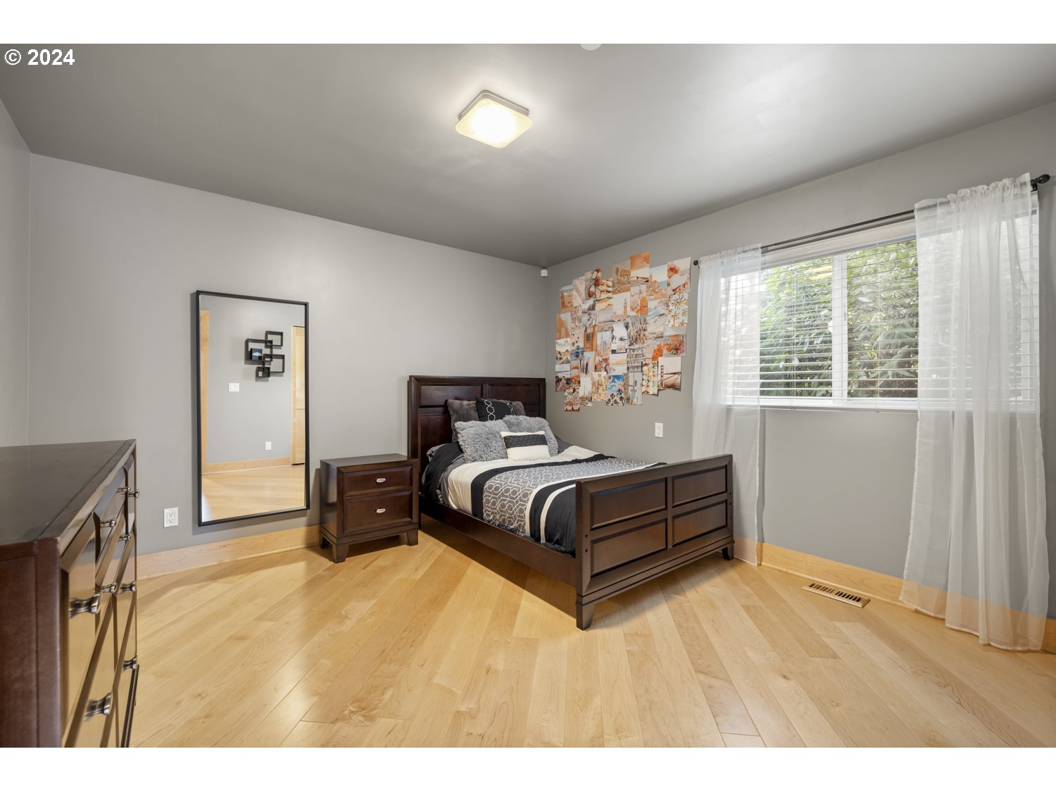 8857 Southwest Edgewood Street Tigard, OR 97223 - Photo 28 of 48 a spacious bedroom with a bed and a dresser