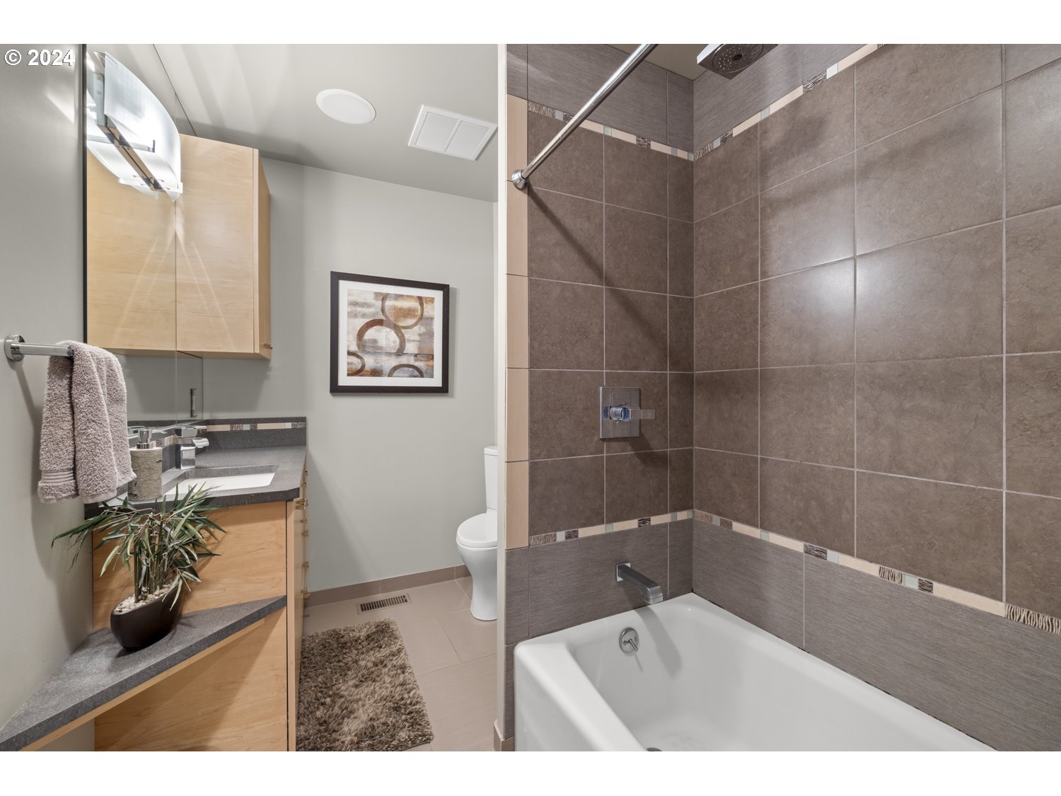 8857 Southwest Edgewood Street Tigard, OR 97223 - Photo 32 of 48 a bathroom with a sink a toilet and a shower