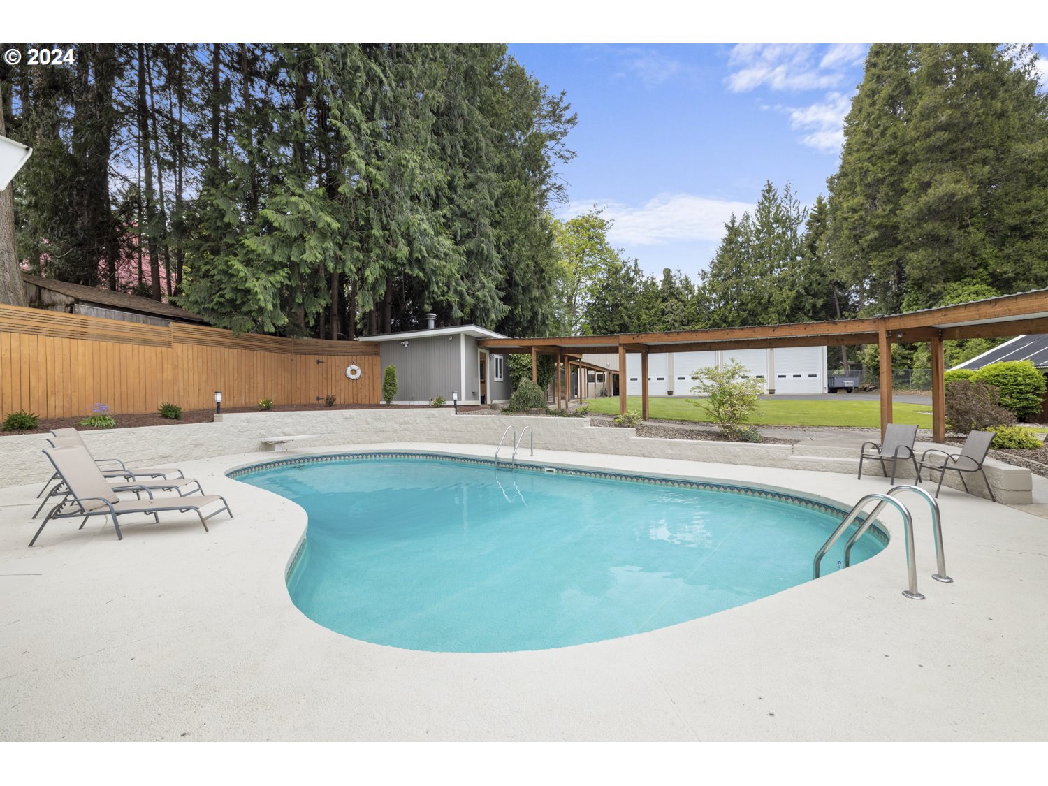 8857 Southwest Edgewood Street Tigard, OR 97223 - Photo 34 of 48 a view of a swimming pool with a lounge chair