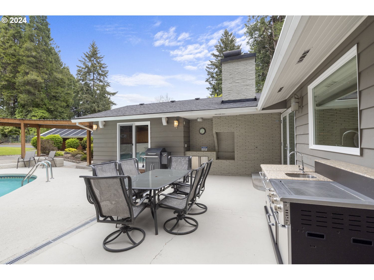 8857 Southwest Edgewood Street Tigard, OR 97223 - Photo 35 of 48 a view of house with patio and outdoor seating