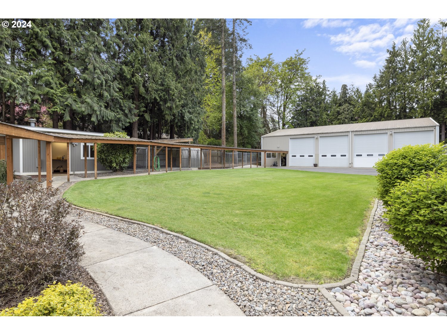 8857 Southwest Edgewood Street Tigard, OR 97223 - Photo 38 of 48 a view of a white house with a swimming pool
