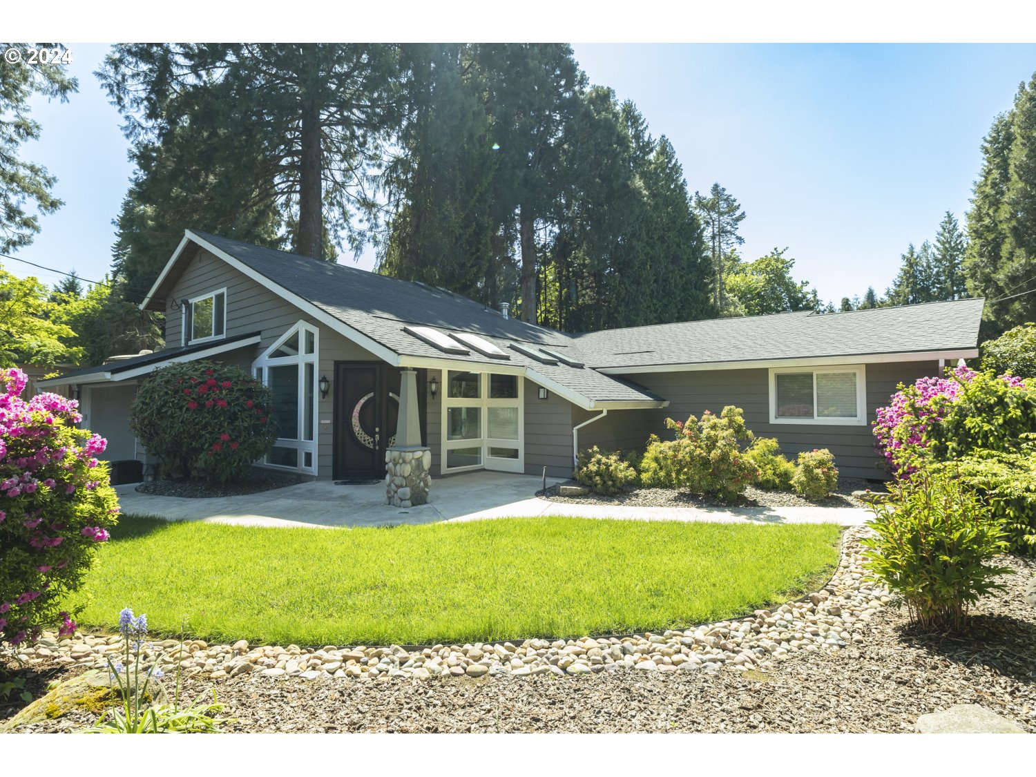 8857 Southwest Edgewood Street Tigard, OR 97223 - Photo 5 of 48 a front view of a house with a yard and porch