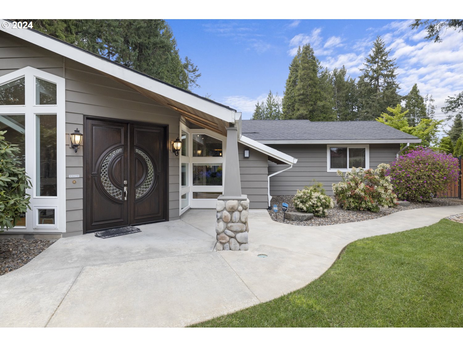 8857 Southwest Edgewood Street Tigard, OR 97223 - Photo 6 of 48 a view of a house with backyard and trees