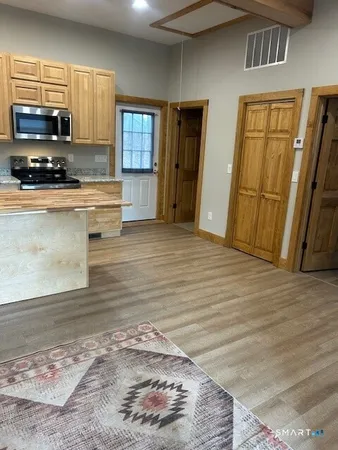 a kitchen with stainless steel appliances wooden cabinets a stove and a refrigerator