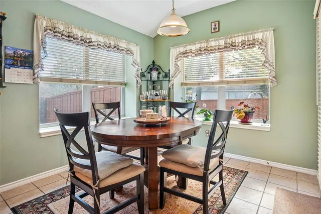a view of a dining room with furniture and window