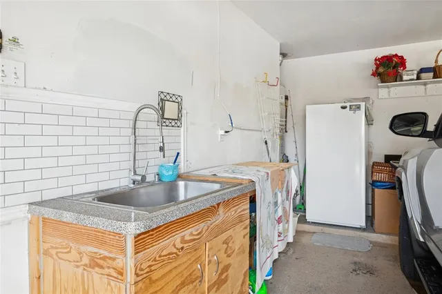 a kitchen with stainless steel appliances granite countertop a sink a refrigerator and a stove