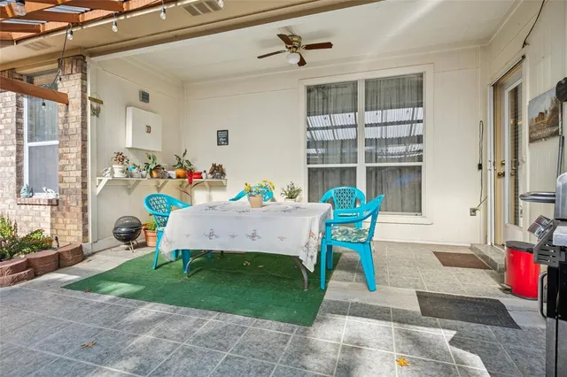 a view of a dining room with a table and chairs