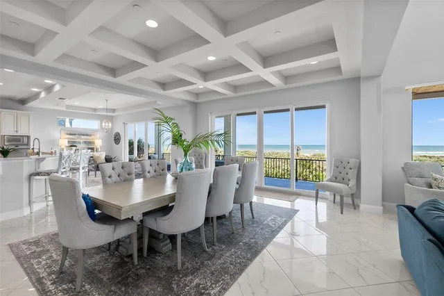 a kitchen with a dining table chairs and white stainless steel appliances