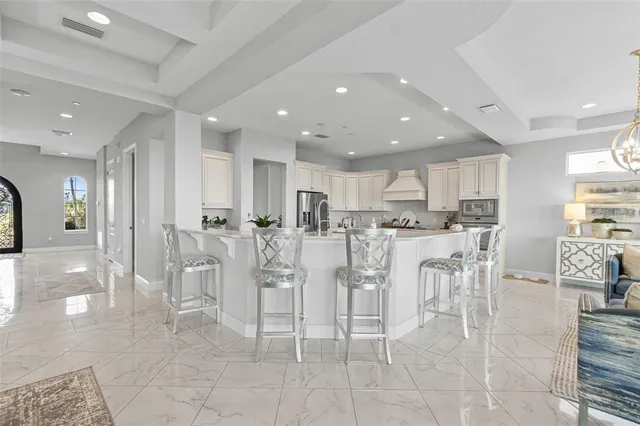 a kitchen with white cabinets and sink