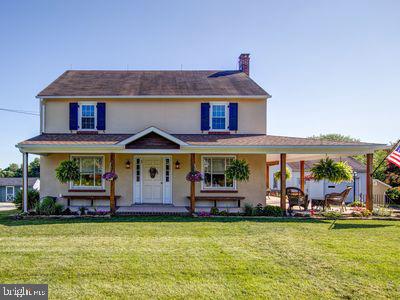 an aerial view of a house with swimming pool a yard and a patio