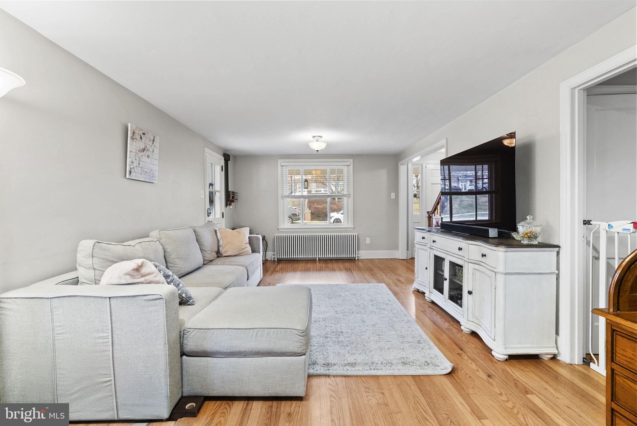 1776 West Doe Run Road Kennett Square, PA 19348 - Photo 12 of 34 a living room with furniture and a flat screen tv
