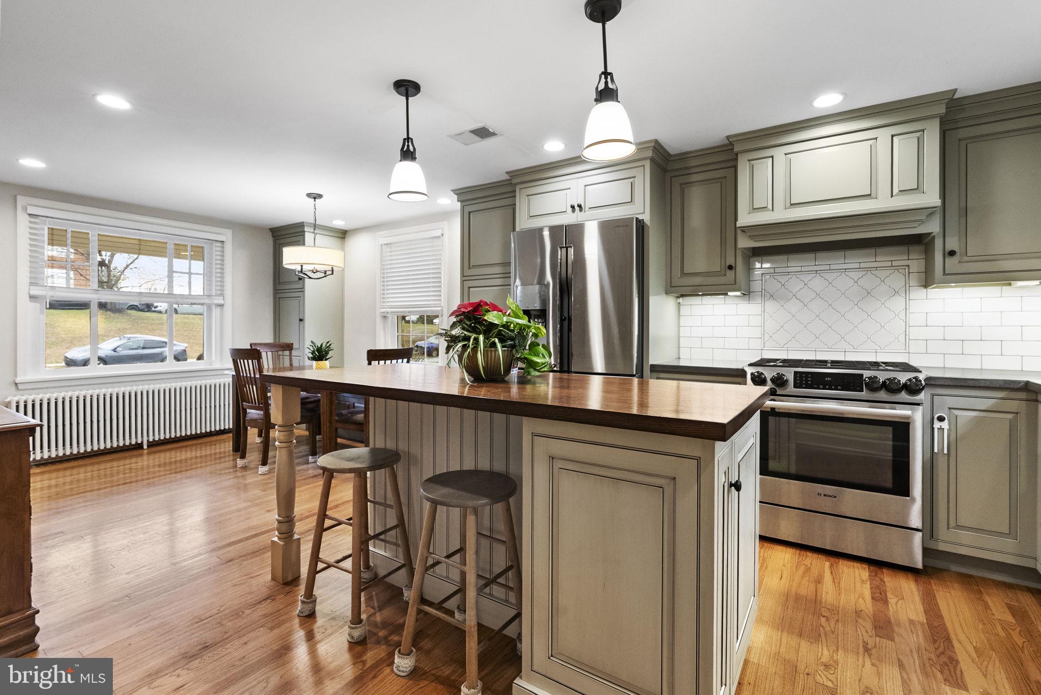 1776 West Doe Run Road Kennett Square, PA 19348 - Photo 16 of 34 a kitchen with stainless steel appliances granite countertop wooden cabinets a stove a sink a dining table and chairs