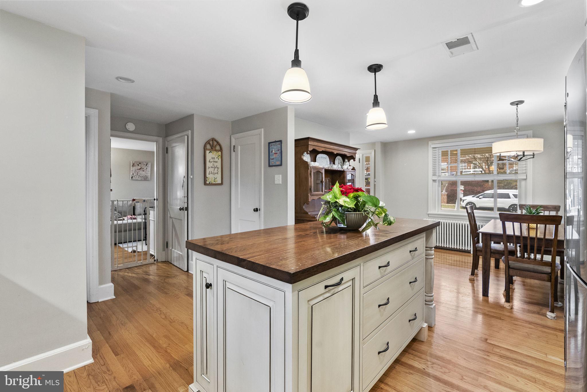 1776 West Doe Run Road Kennett Square, PA 19348 - Photo 17 of 34 a kitchen with white cabinets and chandelier