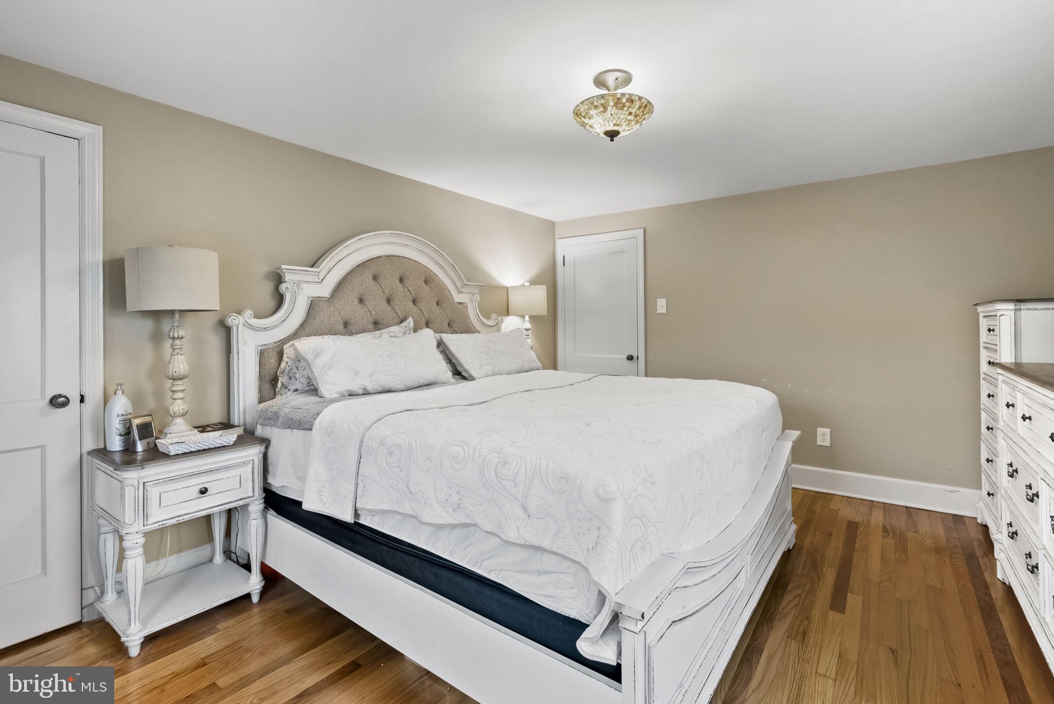 1776 West Doe Run Road Kennett Square, PA 19348 - Photo 22 of 34 a bedroom with a bed and a chandelier