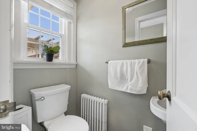 a white toilet sitting next to a bathroom sink