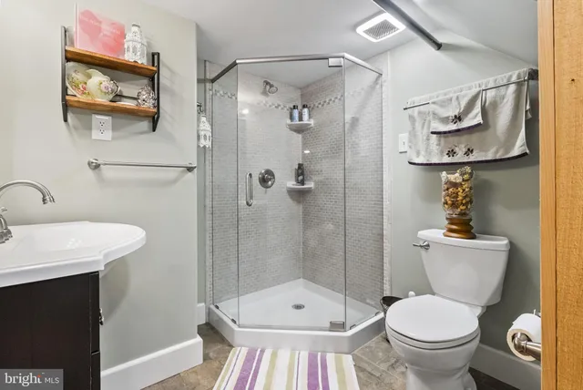 a bathroom with a toilet a sink and shower